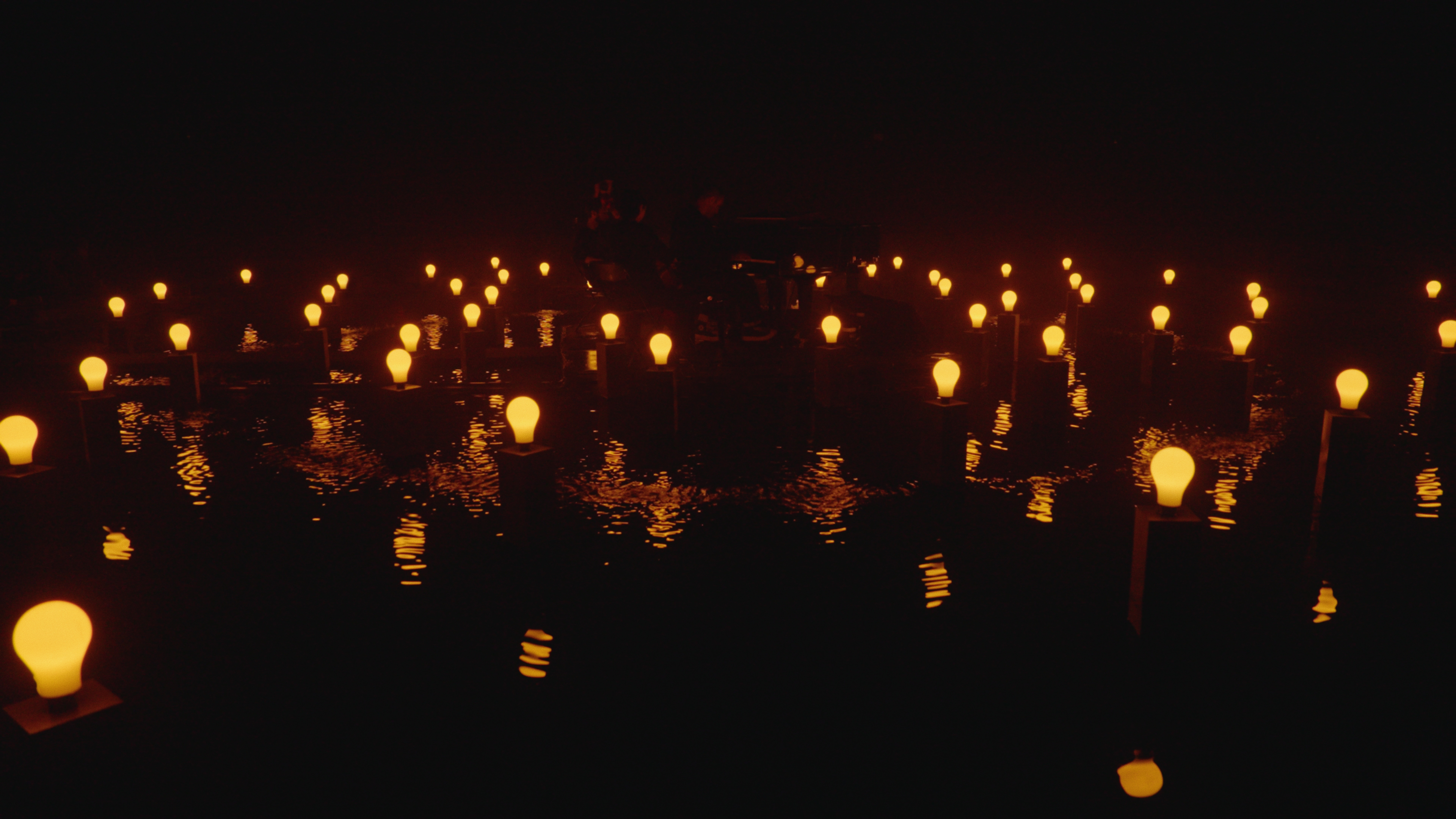 Warm bulbs reflected on water
